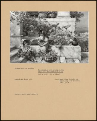 Two Children With A Baby On The Steps Of A Mediterranean Villa